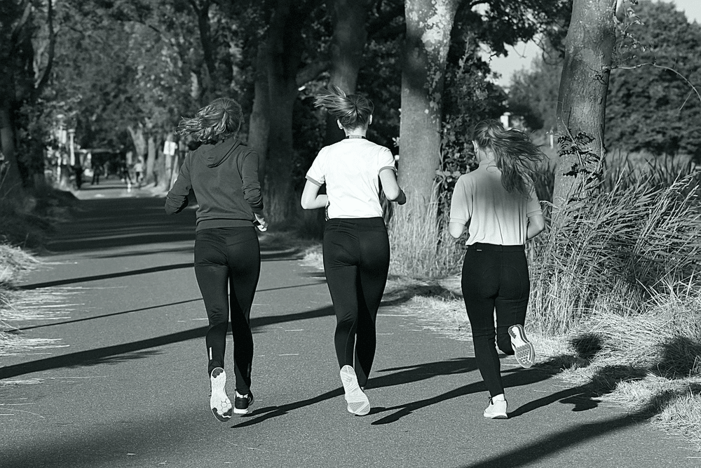 Adults jogging outdoors to support gut and overall health after 40